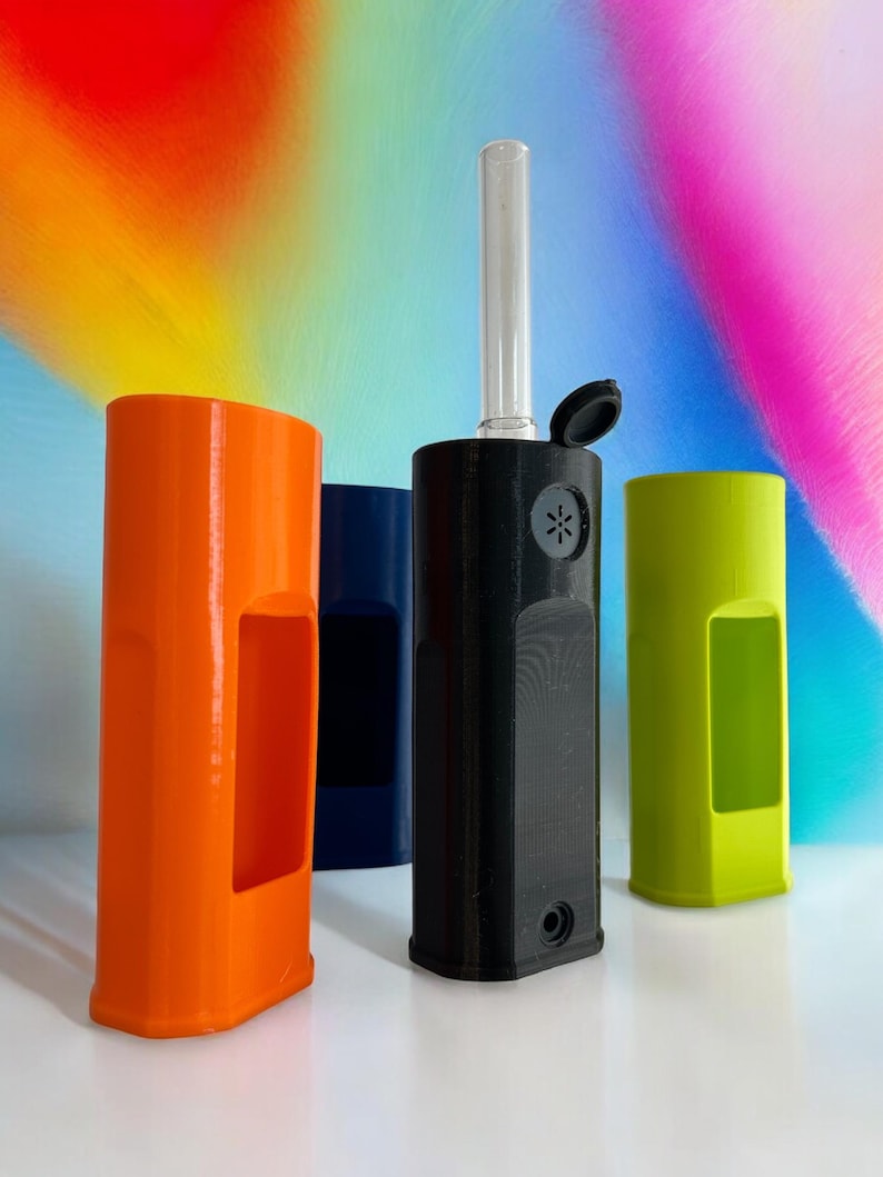 May include: Four different colored cases for a vaporizer, one is black, one is orange, one is green, and one is blue. The cases have a small opening for the mouthpiece of the vaporizer.