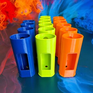 May include: A row of colorful, cylindrical containers with a hole in the center. The containers are arranged in a rainbow pattern, with blue, green, and orange containers.