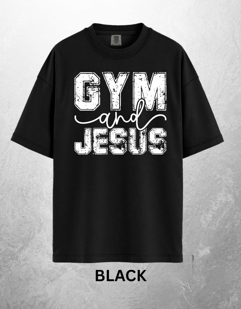 May include: Black t-shirt with the text "GYM and JESUS" in distressed white lettering. The word "and" is in a cursive font. The word "BLACK" is printed at the bottom of the shirt.
