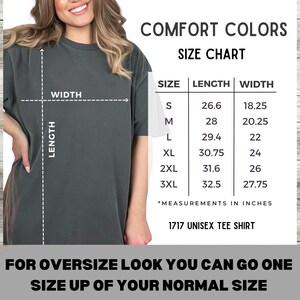 May include: A dark gray unisex t-shirt with a size chart. The chart shows measurements in inches for sizes S to 3XL. The text reads "COMFORT COLORS" and "1717 UNISEX TEE SHIRT". The image also includes the text "FOR OVERSIZE LOOK YOU CAN GO ONE SIZE UP OF YOUR NORMAL SIZE."