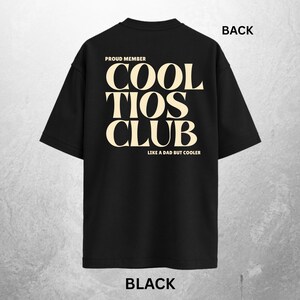 May include: Black t-shirt with the text "COOL TIOS CLUB" in a cream-colored font. The text "PROUD MEMBER" is above the main text, and "LIKE A DAD BUT COOLER" is below. The word "BACK" is printed at the top.
