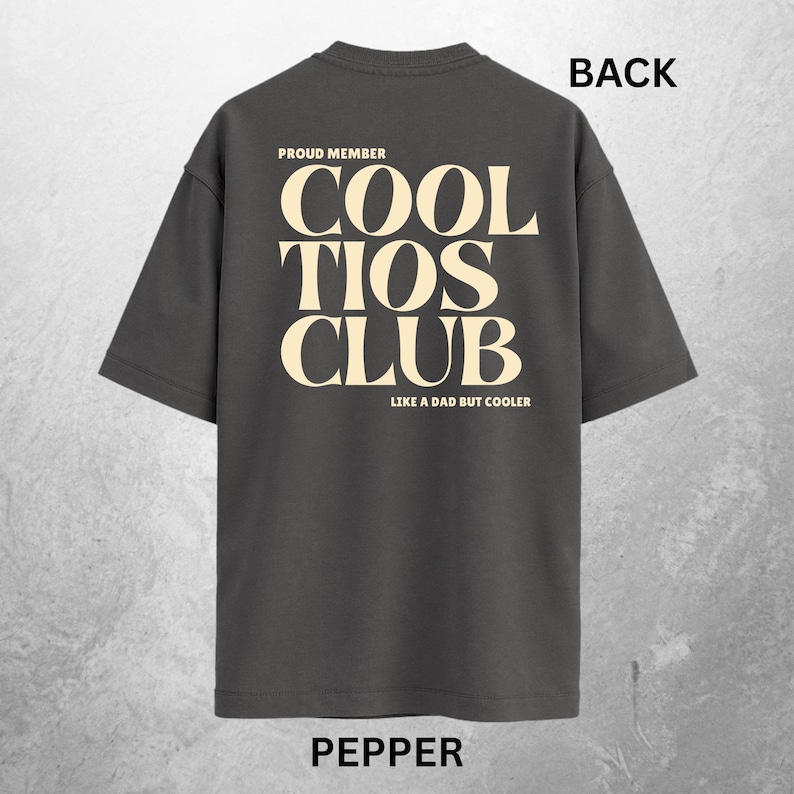May include: Pepper-colored t-shirt with the text "PROUD MEMBER COOL TIOS CLUB LIKE A DAD BUT COOLER" in a cream-colored font. The word "BACK" is printed in black at the top. The word "PEPPER" is printed in black at the bottom.