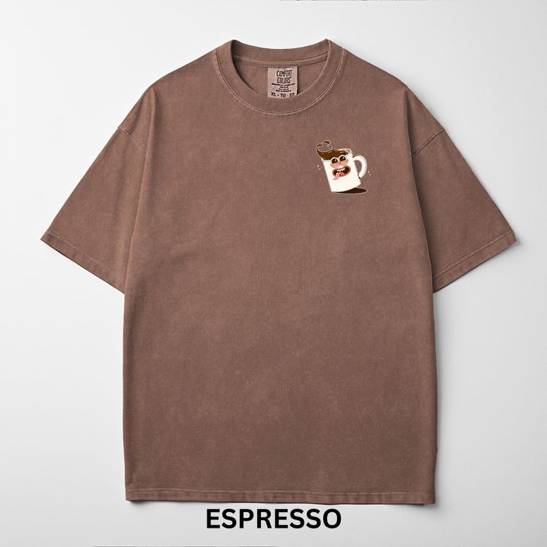 May include: Brown t-shirt with a crew neck and short sleeves. The shirt features a cartoon coffee cup graphic on the front and the word "ESPRESSO" at the bottom. The shirt has a vintage, washed look.