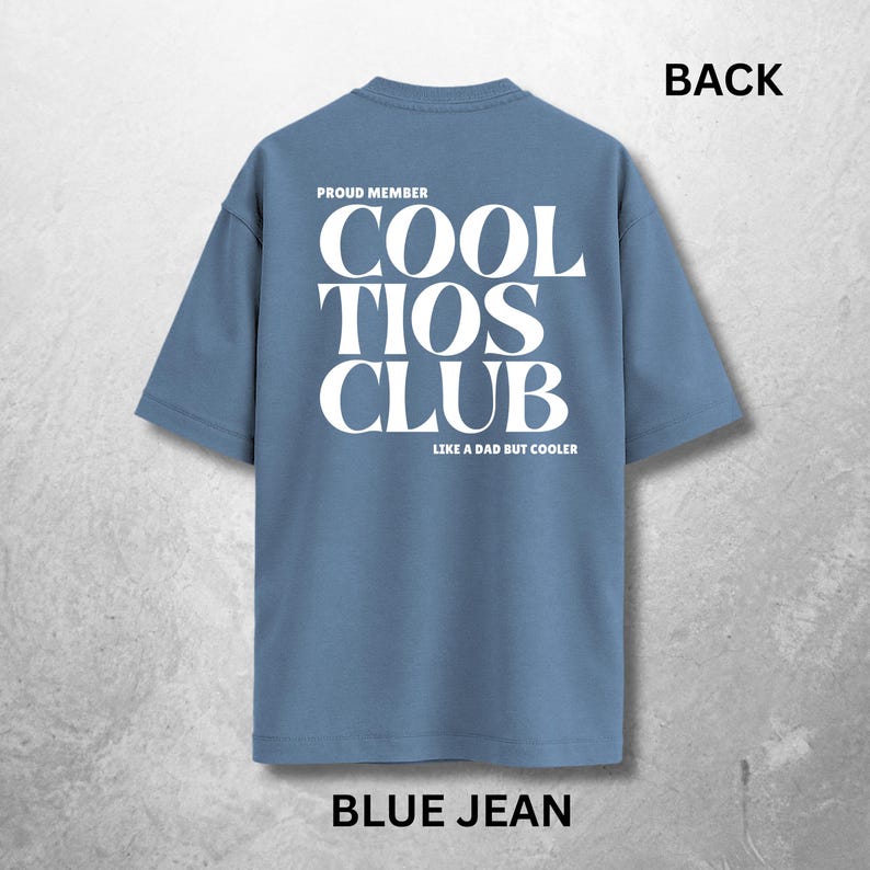 May include: Blue jean-colored t-shirt with the text "COOL TIOS CLUB" in large white letters on the back. The text "PROUD MEMBER" is above the club name, and "LIKE A DAD BUT COOLER" is below. The word "BACK" is at the top.
