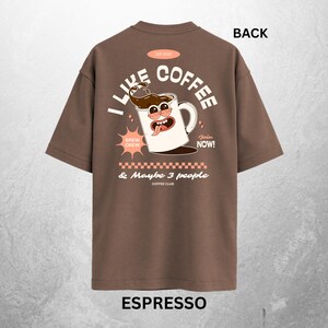 May include: Espresso-colored t-shirt with a graphic on the back that says "I Like Coffee" in white letters. The graphic includes a cartoon coffee mug with a face, and the text "& Maybe 3 people Coffee Club".