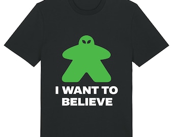 May include: Black t-shirt with a green alien-shaped game piece and the text "I WANT TO BELIEVE" in white.