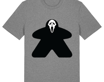 May include: Mid Heather Grey t-shirt featuring a black and white graphic of a game piece with a Scream mask design. The t-shirt has a crew neck and short sleeves. The text "Mid Heather Grey" is at the bottom right.