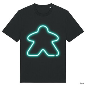 May include: Black t-shirt featuring a neon green outline of a board game meeple.