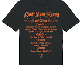 May include: Black t-shirt with the words "Bad Moon Rising" in orange, along with a list of character names. The shirt features a decorative floral design above the text and a small illustration at the bottom.