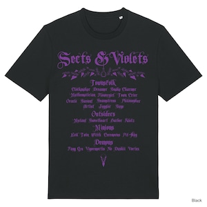 May include: Black t-shirt featuring the words "Sects & Violets" in purple gothic font. The shirt lists various words such as "Townsfolk", "Outsiders", "Minions", and "Demons". The word "Black" is at the bottom right.