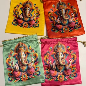 May include: Four colorful drawstring bags. Each bag features a vibrant illustration of a deity with an elephant head. The bags are in yellow, red, green, and pink, with gold trim and drawstrings.