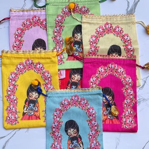 May include: Set of six colorful drawstring bags with a floral design and a depiction of a woman holding a baby. Each bag has a different color and features a different floral pattern.
