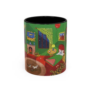 May include: A green and red ceramic mug with a black rim. The mug features a whimsical illustration of a bedroom with a bed, a fireplace, and a cat. The text "Goodnight Moon" is visible on the mug.
