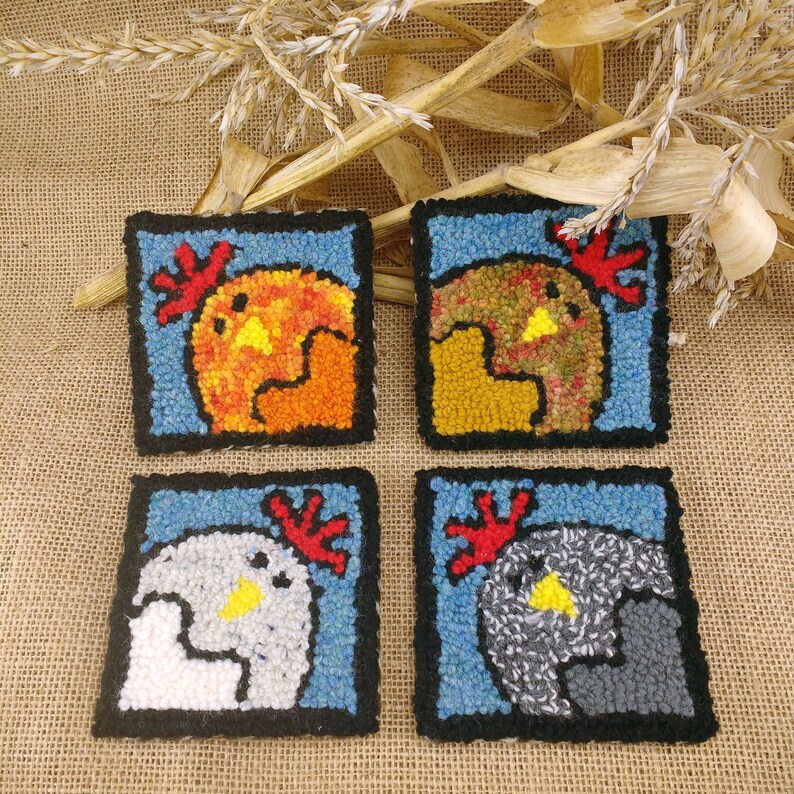 May include: Four square felt coasters with a colorful chicken design. Each coaster features a different color scheme, including orange, yellow, brown, gray, and white.