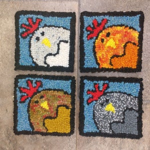 May include: Four colorful square rug patches with a rooster design. Each rug patch features a different colored rooster with a red comb and wattle. The roosters are white, orange, brown, and gray.