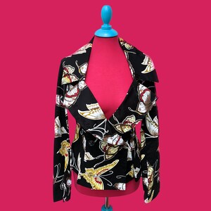 May include: A black jacket with a butterfly print. The jacket has a shawl collar and a button closure. The butterflies are in shades of yellow, red, and white.