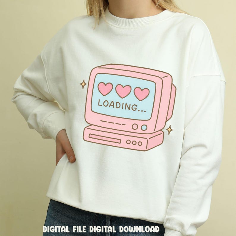 May include: White sweatshirt featuring a pink retro computer graphic with three hearts and the word "LOADING...". The design includes sparkling star accents. The text "DIGITAL FILE DIGITAL DOWNLOAD" is at the bottom.