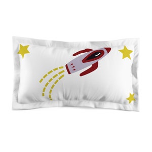 May include: White pillowcase with a red and gray rocket ship flying through the air with a yellow trail. There are three yellow stars on the pillowcase.