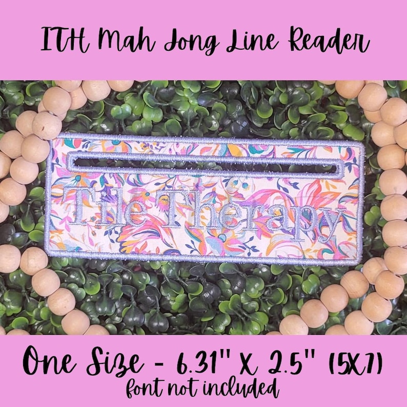 May include: A rectangular Mah Jong Line Reader with the text "Tile Therapy" embroidered on a floral fabric. The reader is 16 cm long and 6.35 cm wide. The text "ITH Mah Jong Line Reader" is above the reader.