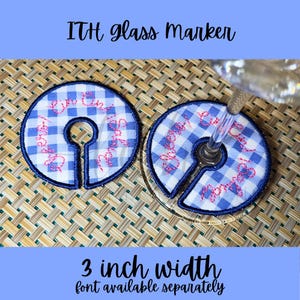 May include: Blue and white gingham glass markers with pink embroidered text. The markers are 3 inches wide and have a keyhole shape to fit around a glass stem. The text "Love You" is embroidered on the markers. The text "ITH glass marker" is at the top.
