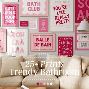 May include: A collection of pink and white bathroom-themed prints, including phrases like "Bath Club" and "You're Like Really Pretty." The prints are displayed above a beige sofa, creating a stylish and coordinated wall decor.