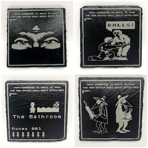May include: Four black slate coasters with white text and graphics. The coasters feature retro video game themes, including a pair of eyes, a pixelated character holding a ball, a pixelated character in a bathroom, and two characters in black suits.