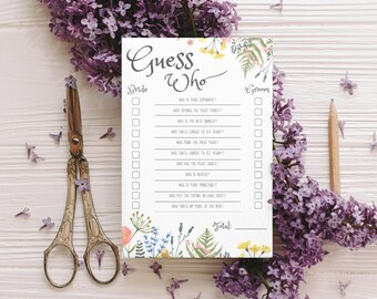 May include: A "Guess Who" game card with floral accents, a pencil, and vintage scissors, surrounded by purple lilac flowers. The card features fill-in-the-blank questions for a wedding game. The overall theme is wedding and party games.