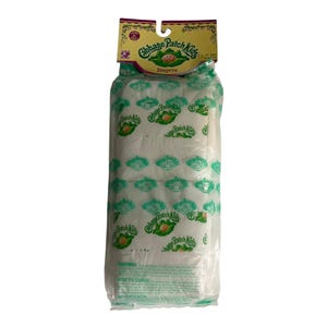 May include: A package of six Cabbage Patch Kids diapers in a clear plastic bag with a yellow cardboard header. The diapers are white and feature a repeating green Cabbage Patch Kids logo and doll face graphic. The header includes the brand name.