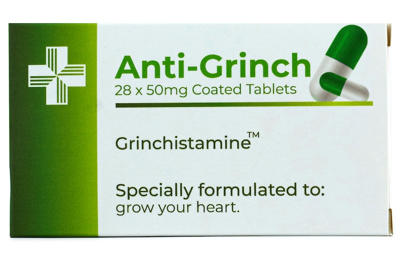 May include: A white box with green accents and a green and white pill. The box reads "Anti-Grinch 28 x 50mg Coated Tablets Grinchistamine&trade; Specially formulated to: grow your heart."