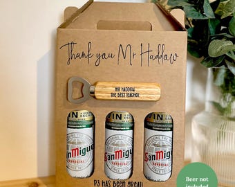 May include: A cardboard gift box with a handle, featuring a bottle opener and three beer cans. The bottle opener has a wooden handle engraved with "MR HADDOW the BEST TEACHER". The box reads "Thank you Mr Haddow" and "P3 has been great! love leyton X".