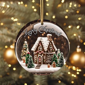 K&ouml;nnte beinhalten: Runder Weihnachtsschmuck mit einem Lebkuchenhaus, einem schneebedeckten Dach und festlichen Akzenten. Der Schriftzug "Merry Christmas" ist in Wei&szlig; gehalten. Der Schmuck h&auml;ngt an einem goldenen Faden.
