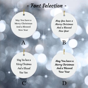 May include: Four white, round Christmas ornaments with gold string hangers. Each ornament displays the message "May You have a Merry Christmas And a Blessed New Year" in a different font style, labeled A, B, C, and D. The text "- Font Selection -" is at the top.