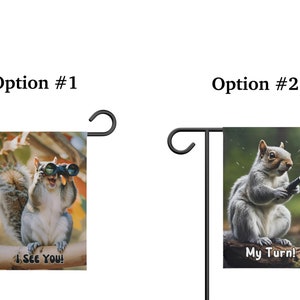 May include: Two garden flags featuring a squirrel. The first flag shows a squirrel wearing binoculars with the text "I See You!" The second flag shows a squirrel holding a hose with the text "My Turn!"