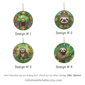 May include: Four round ceramic ornaments with a stained glass design featuring a sloth in a tropical setting. The ornaments are decorated with green leaves, flowers, and pineapples. The sloth is brown with a white face and black eyes. The ornaments are labeled with the numbers 1 through 4.