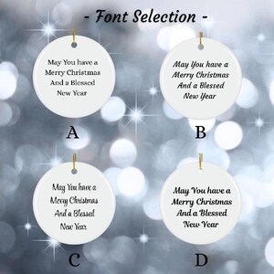 May include: White ceramic Christmas ornaments with gold string hangers. Each ornament displays the message "May You have a Merry Christmas And a Blessed New Year" in different fonts. The text "- Font Selection -" is at the top.