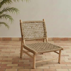 May include: A light-colored wooden chair with a woven seat and back. The chair has a rectangular back and seat made of a natural fiber material. The legs and frame are made of light-colored wood.