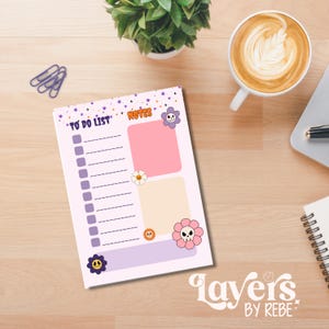 May include: A light purple to-do list notepad with the words "TO DO LIST" and "NOTES" printed on it. The notepad features a floral and star design with pink and peach colored boxes. The notepad has a floral skull design and the words "layers by rebe" printed on it.