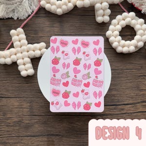 May include: A pink rectangular card decorated with pink hearts, bows, roses, and gift boxes. The card includes the text "XOXO" in heart shapes. The words "DESIGN 4" are at the bottom of the card.