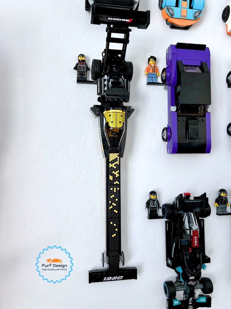 Shows the top fuel dragster car displayed with the minifig using the available wall mount. Other cars can also be seen in the photo but are not the intended focus.