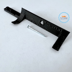 Shows the wall mount for sale with the included nail.