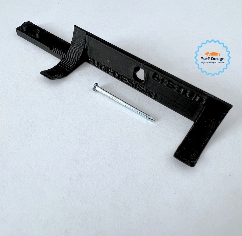 Shows the wall mount for sale with the included nail.