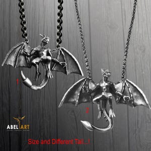 May include: Two silver necklaces featuring a winged gargoyle pendant. The gargoyles are in the same pose, but the tails are different. The text "Size and Different Tail..." is at the bottom of the image.
