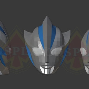 May include: Three-dimensional, geometric mask design in gray and blue. The mask features a stylized face with pointed ears and a central crest. Blue accents highlight the eyes and forehead, creating a futuristic aesthetic. The masks are displayed against a dark gray background.