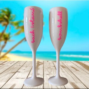 Personalized acrylic champagne flutes with custom Love Island inspired names and colorful vinyl decals. Lightweight reusable 5 oz flutes perfect for bachelorette parties, bridal showers, girls trips, birthdays, and party favors. Customized drinkware with tropical summer aesthetic.