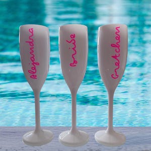 Personalized acrylic champagne flutes with custom Love Island inspired names and colorful vinyl decals. Lightweight reusable 5 oz flutes perfect for bachelorette parties, bridal showers, girls trips, birthdays, and party favors. Customized drinkware with tropical summer aesthetic.