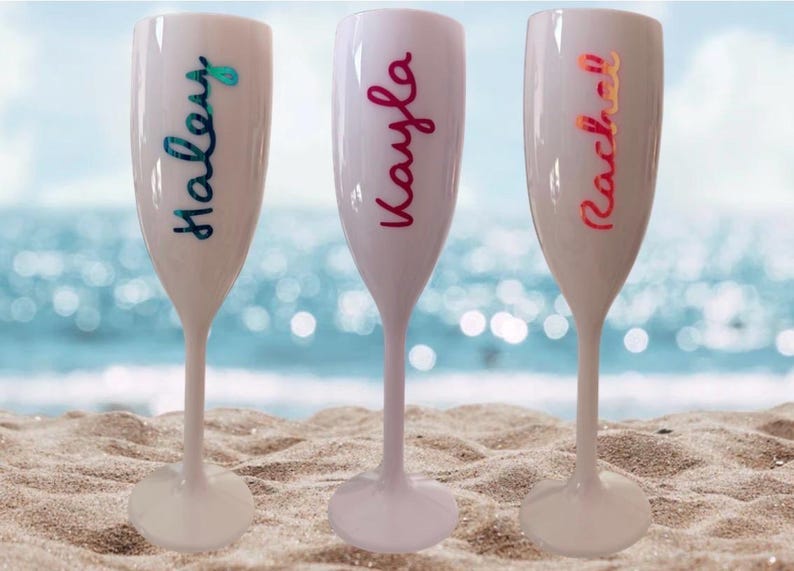 Personalized acrylic champagne flutes with custom Love Island inspired names and colorful vinyl decals. Lightweight reusable 5 oz flutes perfect for bachelorette parties, bridal showers, girls trips, birthdays, and party favors. Customized drinkware with tropical summer aesthetic.