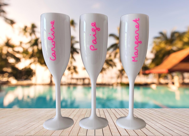 Personalized acrylic champagne flutes with custom Love Island inspired names and colorful vinyl decals. Lightweight reusable 5 oz flutes perfect for bachelorette parties, bridal showers, girls trips, birthdays, and party favors. Customized drinkware with tropical summer aesthetic.