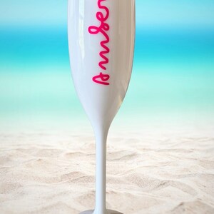 Personalized acrylic champagne flutes with custom Love Island inspired names and colorful vinyl decals. Lightweight reusable 5 oz flutes perfect for bachelorette parties, bridal showers, girls trips, birthdays, and party favors. Customized drinkware with tropical summer aesthetic.