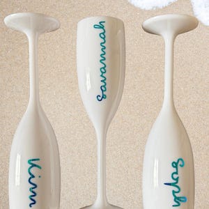 Personalized acrylic champagne flutes with custom Love Island inspired names and colorful vinyl decals. Lightweight reusable 5 oz flutes perfect for bachelorette parties, bridal showers, girls trips, birthdays, and party favors. Customized drinkware with tropical summer aesthetic.