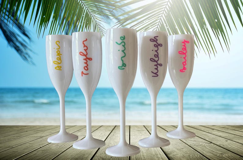 Personalized acrylic champagne flutes with custom Love Island inspired names and colorful vinyl decals. Lightweight reusable 5 oz flutes perfect for bachelorette parties, bridal showers, girls trips, birthdays, and party favors. Customized drinkware with tropical summer aesthetic.